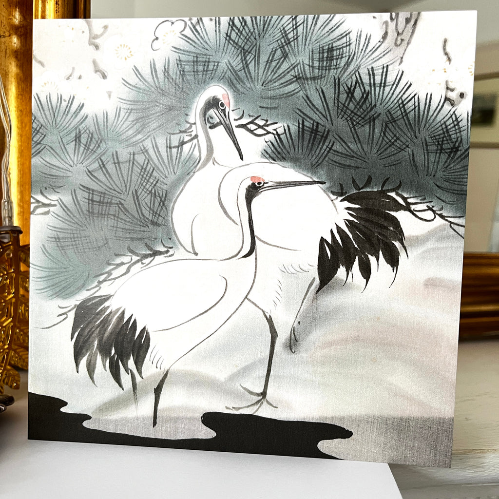 Artistic depiction of two cranes among trees on a textured paper background